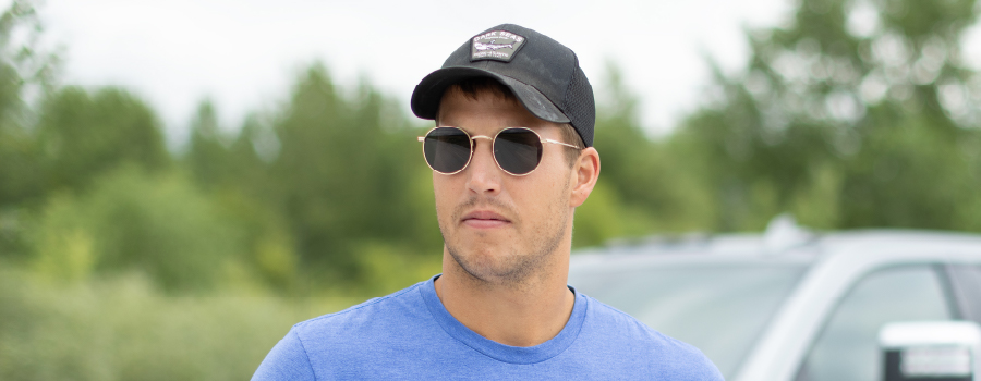 Headshot of Logan Rath wearing a Champion Seed ball cap and sunglasses
